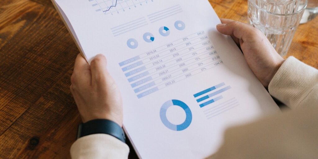 A lender employee looks at charts to analyze a small business's creditworthiness.