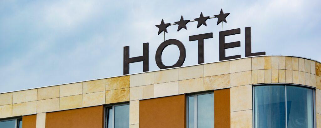 A sign that says "Hotel" on top of a hotel.