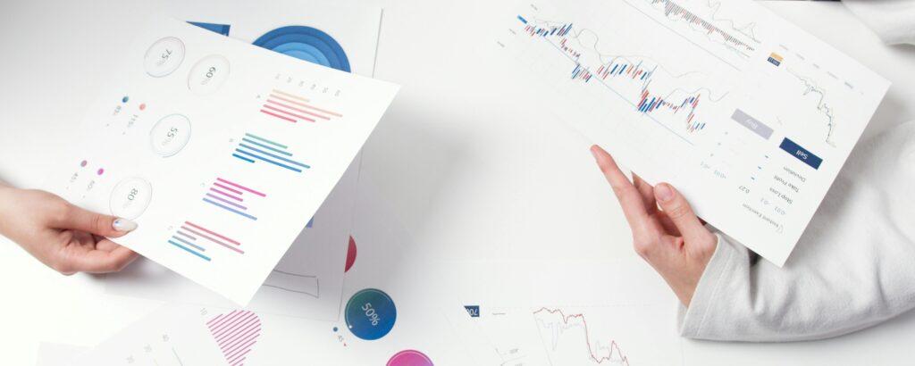 Two bank employees study a business's financials.