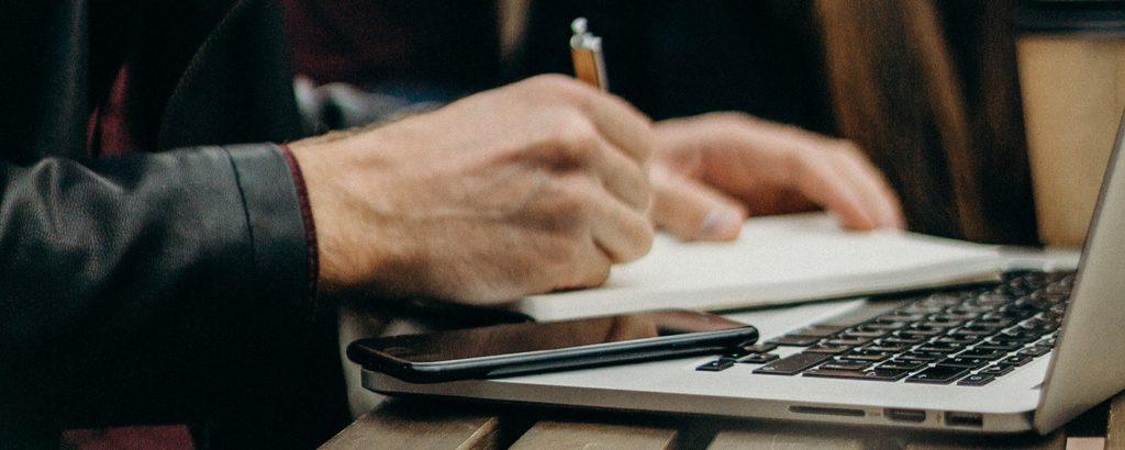 small-business-owner-leather-jacket-notes-seo A small business owner in a leather jacket taking notes.